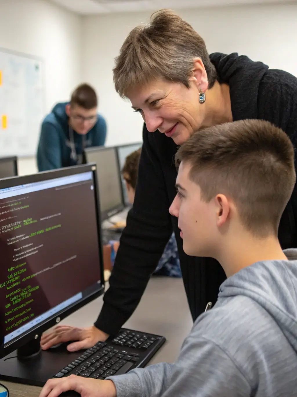 An instructor at digitaluk.site guiding a student through a complex coding problem, using a whiteboard to illustrate concepts and provide personalized support.